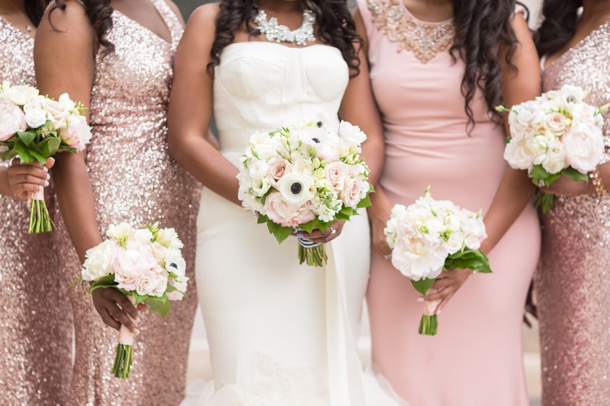 bride with flowers and bridesmaids