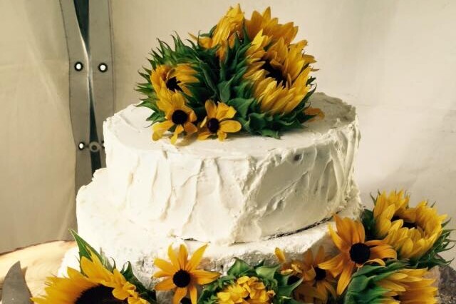 white frosted cake with yellow sunflowers